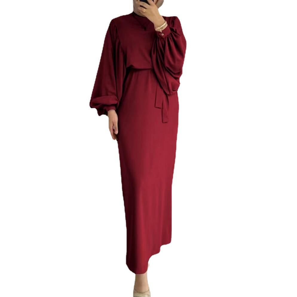 A tight-fitting, low-cut, long-sleeved dress