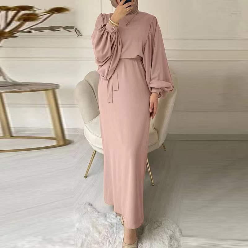 A tight-fitting, low-cut, long-sleeved dress