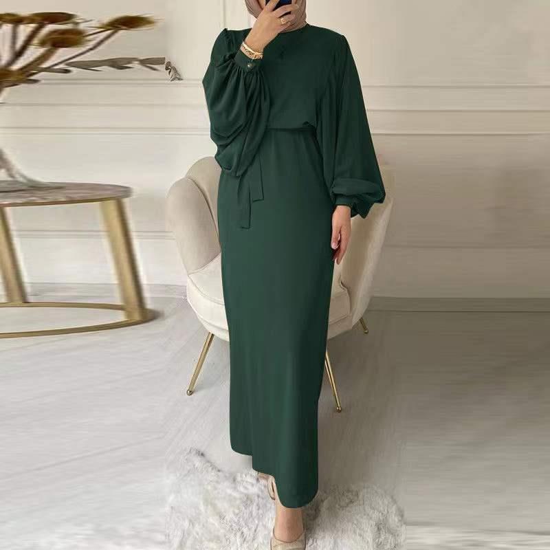 A tight-fitting, low-cut, long-sleeved dress