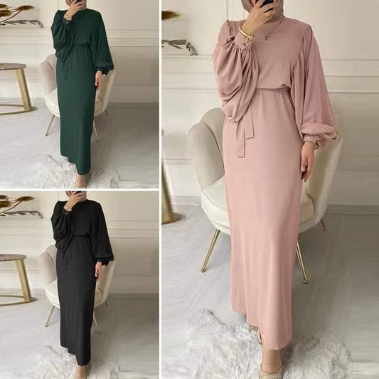A tight-fitting, low-cut, long-sleeved dress