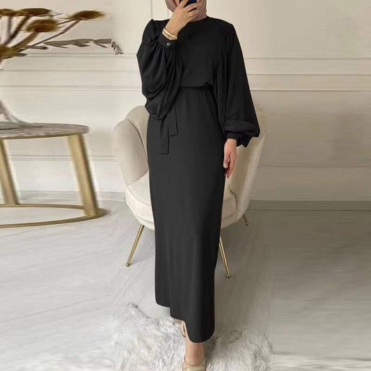 A tight-fitting, low-cut, long-sleeved dress